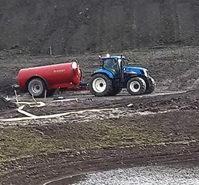 Aberdeenshire plant hire: tractor pulling a trailer in field